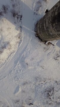 Belgo Factory Shawinigan Quebec Canada FPV drone flying close to abandoned concrete silos with snow covered ground, historic industrial site during winter.