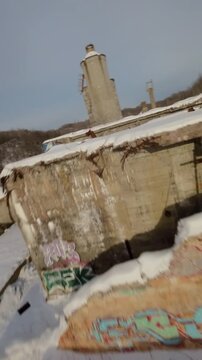 Belgo factory Shawinigan Quebec Canada FPV drone speed flight over abandoned industrial ruins in winter snow, vertical aerial view with raw decay and cold atmosphere.