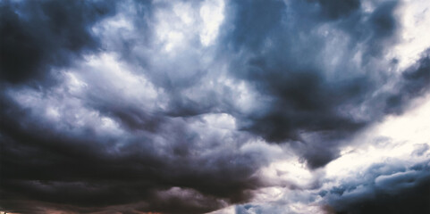 Obraz premium Dark Turbulent Storm Clouds Swirling Across The Sky In Deep Blues And Grays, Signaling Approaching Heavy Weather And Creating A Dramatic, Powerful And Intensely Moody Atmospheric Scene