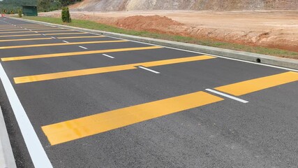 Rumble strips are visible on the roadside. These safety features are installed to provide an auditory and tactile alert to drivers, promoting road awareness.