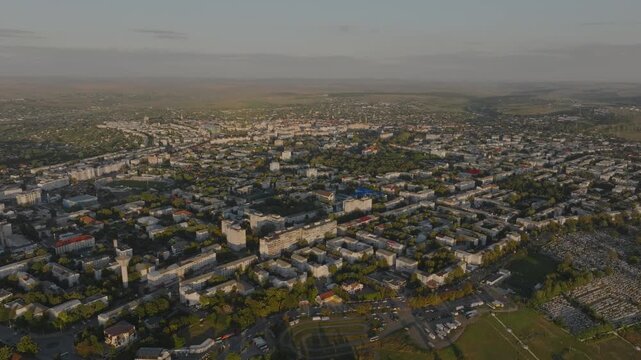 Flyover Botosani, emblematic north east Romanian city in warm sunset - 4k aerial