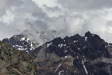The enchanting beauty of the snowy mountains. The view of snow and rocks on the mountain tops.