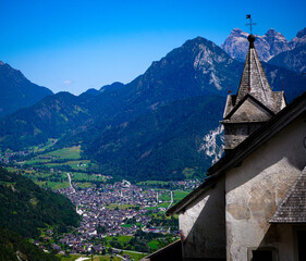 Fototapeta premium Alpine village in a green mountain valley with traditional architecture