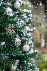 Close-up of Christmas tree decoration ornament, with fake snow soap bubbles, with blur bokeh background.