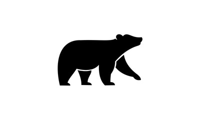 Fototapeta premium Silhouette of a black bear walking on a white background.