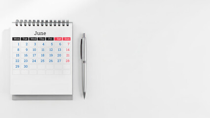 June calendar and pen on white background with copy space for design