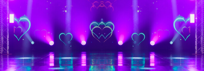 An empty stage of the theater, lit by spotlights and smoke before the performance