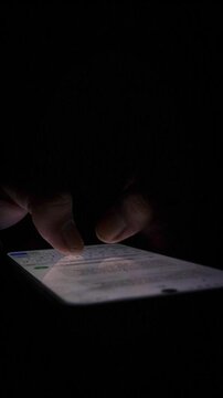 Night, cybersecurity and hands typing with phone for texting, internet troll or person cyberbullying. Dark comment, social media netizen or keyboard warrior, online bullying or hacking. vertical.