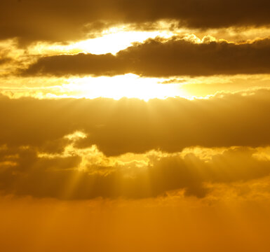 The sun is shining through the clouds