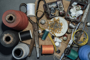 Thimbles in small wooden treasure chest, Spools of thread of various colour, Sewing needles stuck in a green miniature spools thread, Steel scissors and Measuring tape including pins in small round tr