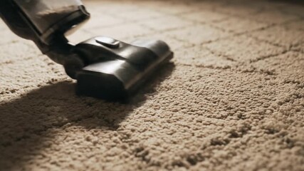 Close-up of a vacuum cleaner in action on a textured carpet, showcasing effective cleaning in a cozy room
