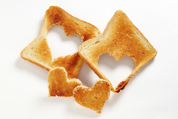 Toasted bread with cut out heart-shaped slice