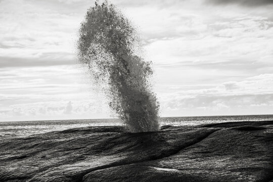Waves crashing the rocky shore - Powered by Adobe