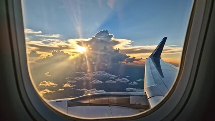 Stunning golden sunrise view from airplane window with beautiful clouds and airplane wing visible - Powered by Adobe