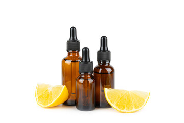 Lemon essential oil in a bottle with sliced ​​lemon and leaves isolated on a white background. Lemon oil. Perfume bottle with aromatic essential oil. Serum, lemon extract. Vitamin C. 