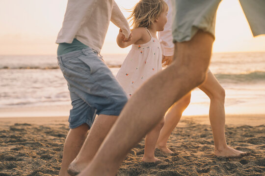 Family enjoying quality time together on the beach at sunset
