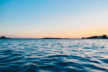 Calm Sea at Sunset with Horizon and Clear Sky