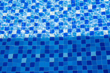 Blue Swimming Pool Tiles with Water Ripples and Light Reflection