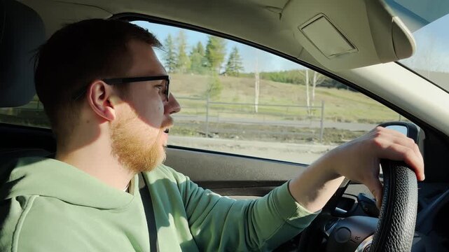 Driving a car. Man wearing glasses. Slow motion. High quality 4k footage