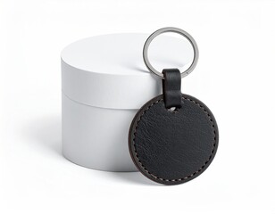 Round leather keychain with metal ring and a white cylinder
