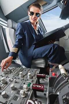 Flight captain in airplane cockpit preparing for flight