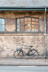 Bicycle Parked Against an Old Brick Wall Facade in Copenhagen