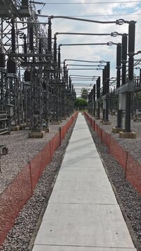 Cinematic B-roll of high voltage electrical substation switchyard with industrial power grid equipment.