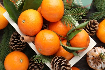Ripe tangerines, spices, fir tree branches and cones on table, flat lay