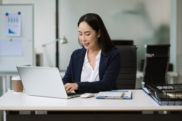 Businesswoman working with laptop, smartphone, and tablet. modern digital workspace concept.