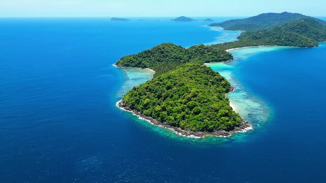 Tropical Paradise Island: An aerial shot captures an idyllic island paradise, a haven of lush greenery and tranquil turquoise waters that promises an escape into serenity and wonder.