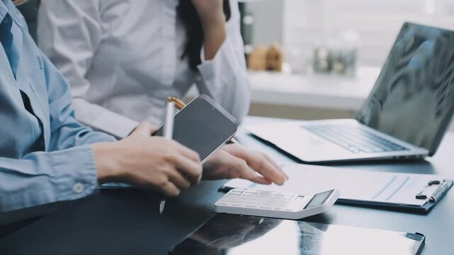 Human use calculator and calculate bills and paying bill, credit card, tax and vat, payment, concept of money management and business report with financial documents, financial accounting concept