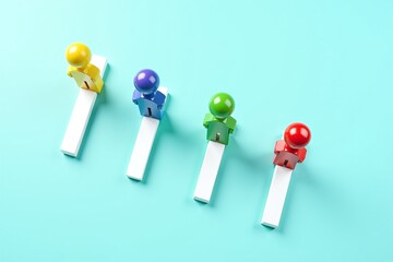 Colorful figurines walk along a narrow path, symbolizing unity and progress in diverse teamwork or journey.