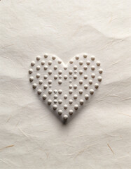 World Braille Day symbolic image with braille dots forming a heart shape on textured paper, representing compassion, inclusion, and accessibility awareness, soft neutral colors