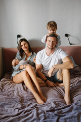 Happy Family Relaxing Together On Bed