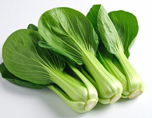 Fresh green leafy bok choy vegetables arranged on a white surface