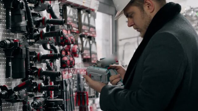 Man in a hardware store looking at technical equipment.