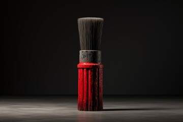 Red paint brush standing on dark background with copy space, representing concepts such as creativity, art, and diy projects