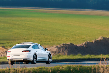 Fototapeta premium Luxury executive sedan driving through countryside