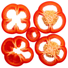 Close-up of sliced red bell pepper, arranged on black, showing seeds and internal structure