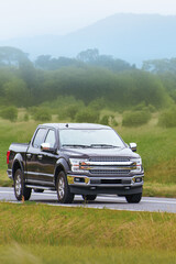 Fototapeta premium Powerful utility truck driving along scenic path