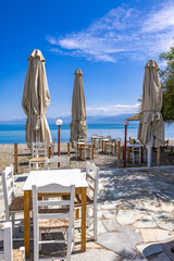 Seaside taverna and pebble beach in Erateini, Greece