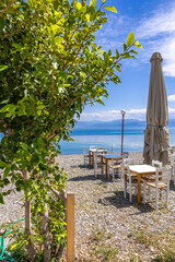 Seaside taverna and pebble beach in Erateini, Greece