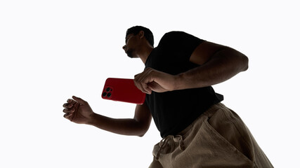 Man moving with smartphone on white background. Concept of active digital lifestyle, mobile technology usage, modern app promotion, and content marketing visuals.
