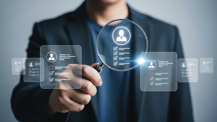 A man examines a futuristic interface with a magnifying glass in a professional setting with icons and graphics.