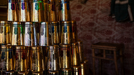 Colorful stacked cups against a patterned background.