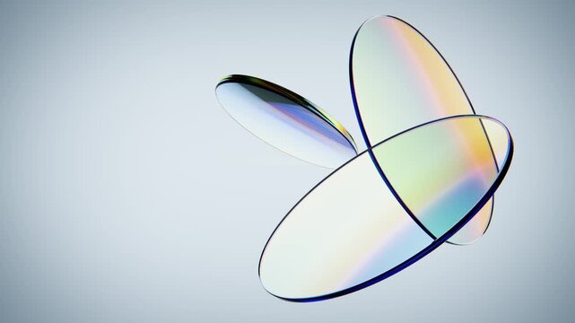 Abstract composition of overlapping iridescent glass discs background. Endless loop.