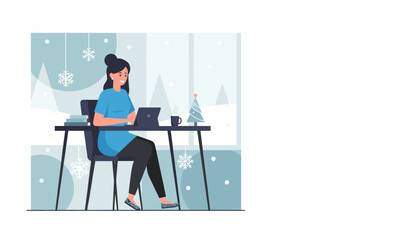 Woman working from home during winter holidays using a digital tablet at her desk with festive decorations