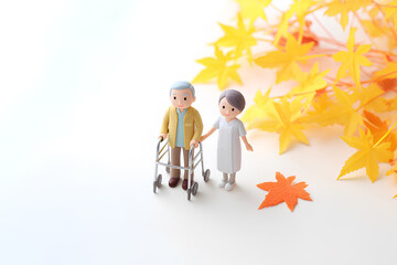 紅葉の中を散歩する車椅子と介護士のやさしい時間／まみおデザイン福祉シリーズ
