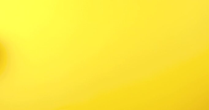 Close-up of human hands holding a cloud storage icon on a bright yellow background. Conceptual 4K video illustrating cloud computing, online data storage, secure backup, and digital technology solutio