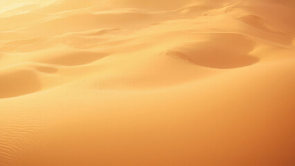 Golden desert sand dunes sculpted by wind under warm sunlight, creating abstract patterns
